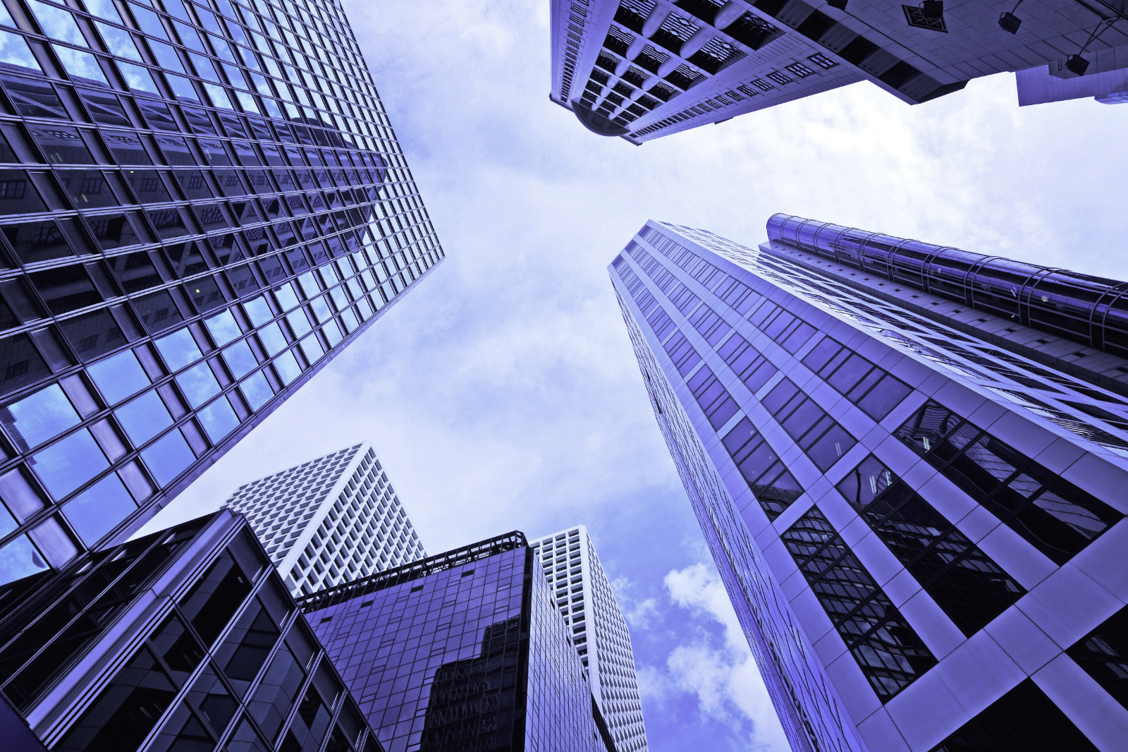 Upward view of modern, sleek skyscrapers, linked to business growth, entrepreneurship & Hong Kong company formation
