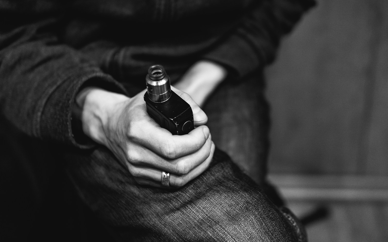 a person holding a bottle of alcohol in their hand