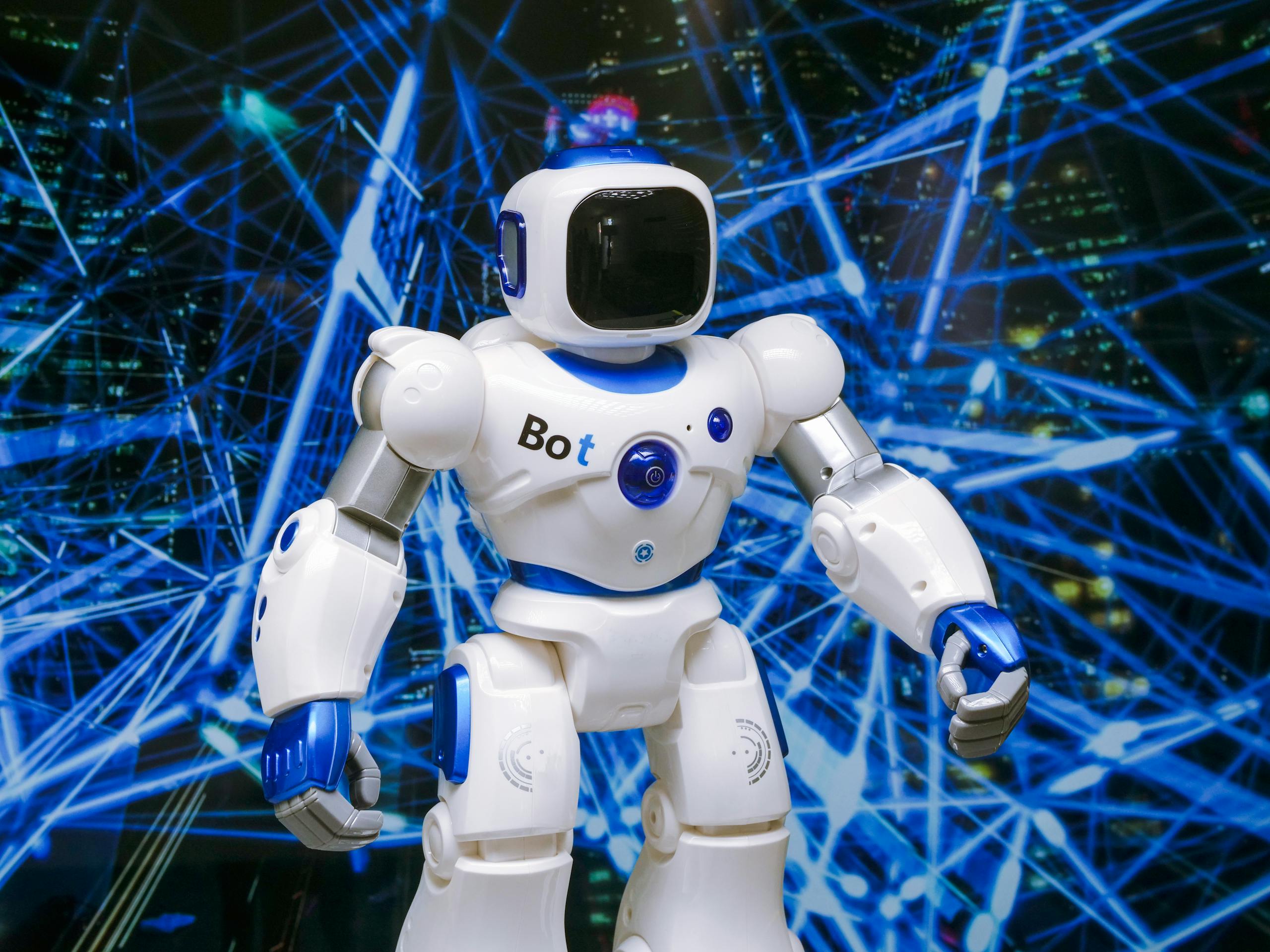 Advanced humanoid robot with glowing blue accents in a digital network setting.