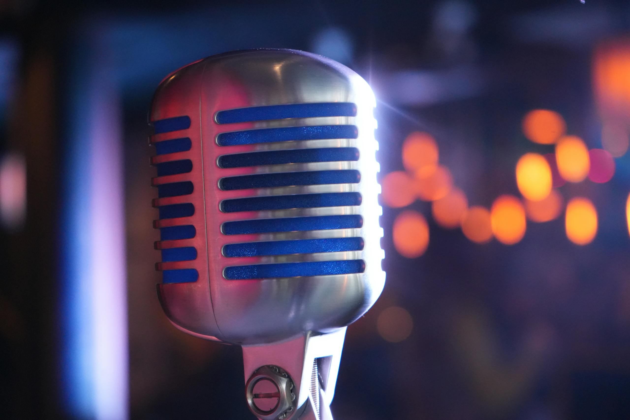 Close-up of a classic microphone with colorful bokeh, ideal for music and performance themes.