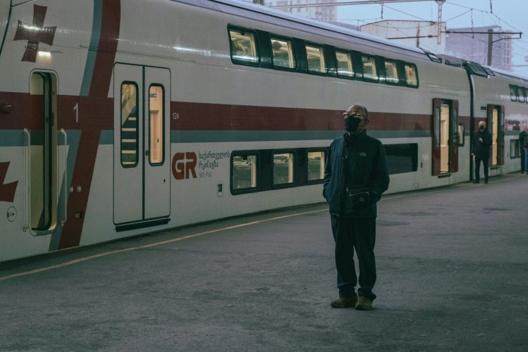 a person standing next to a train