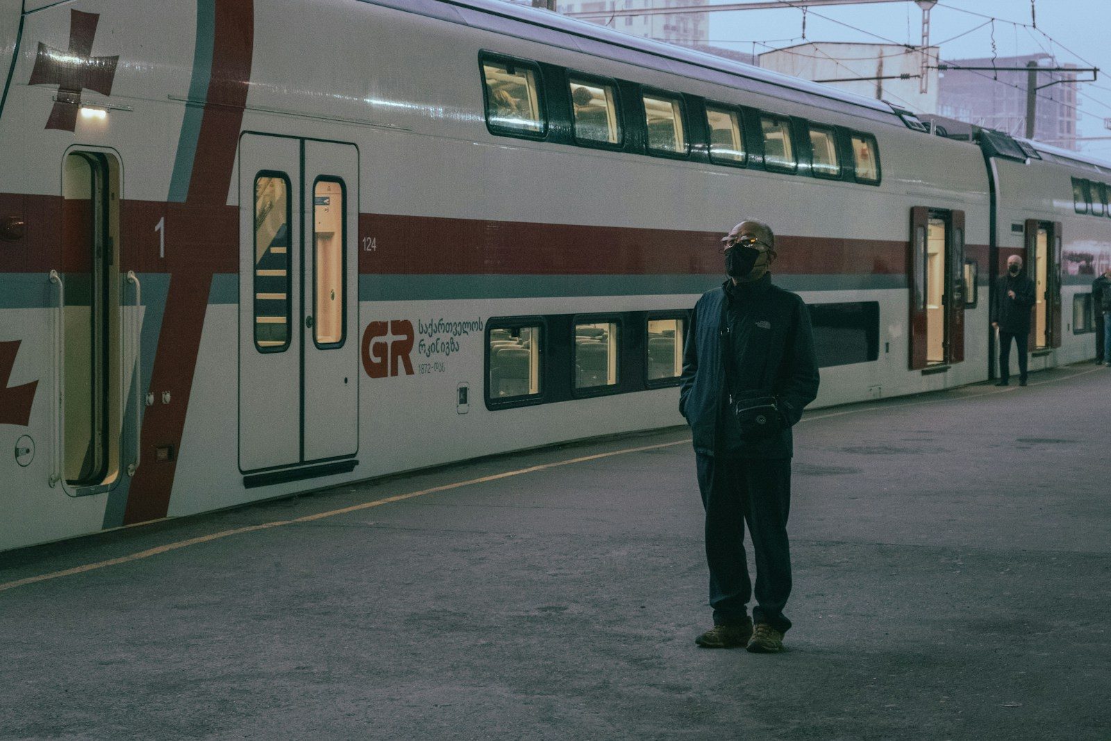 a person standing next to a train
