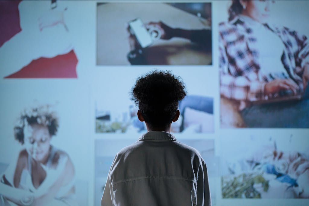 A child stands in front of a digital display showcasing various lifestyle images.