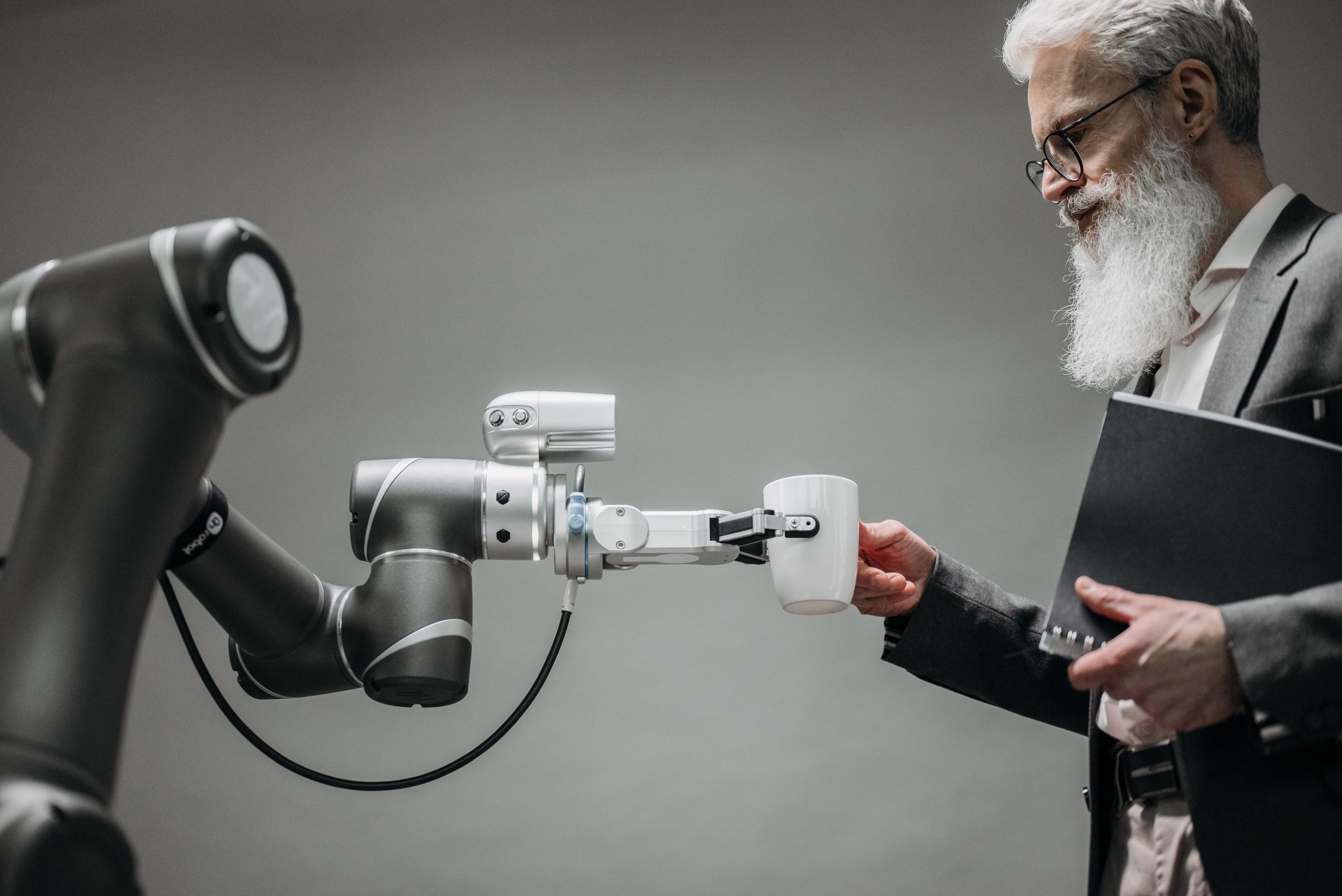 man taking a cup from robot
