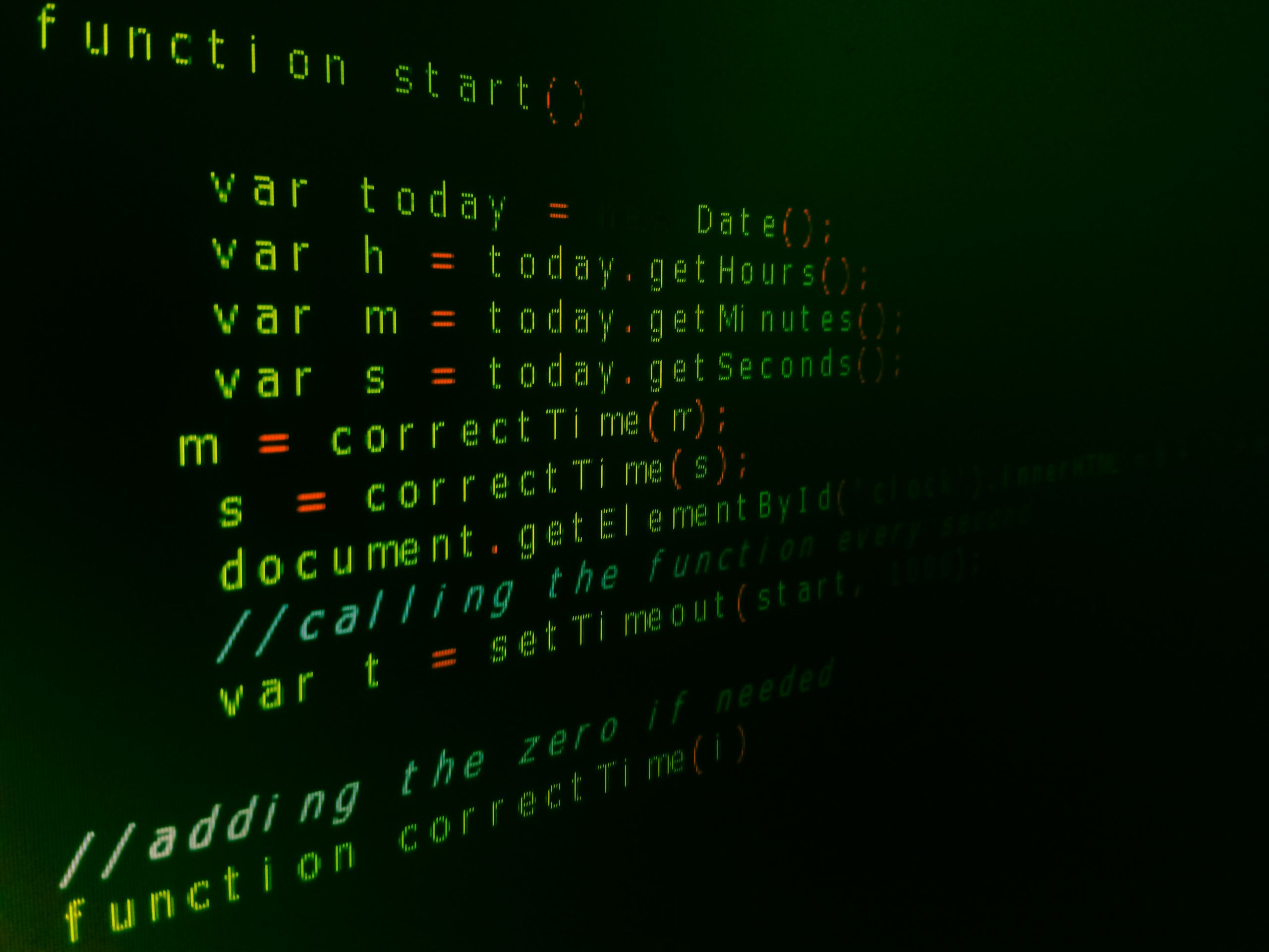 Close-up of JavaScript code on a computer screen with green text highlighting syntax.